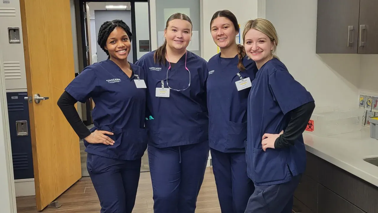 Herzing Dental Assisting students with instructor